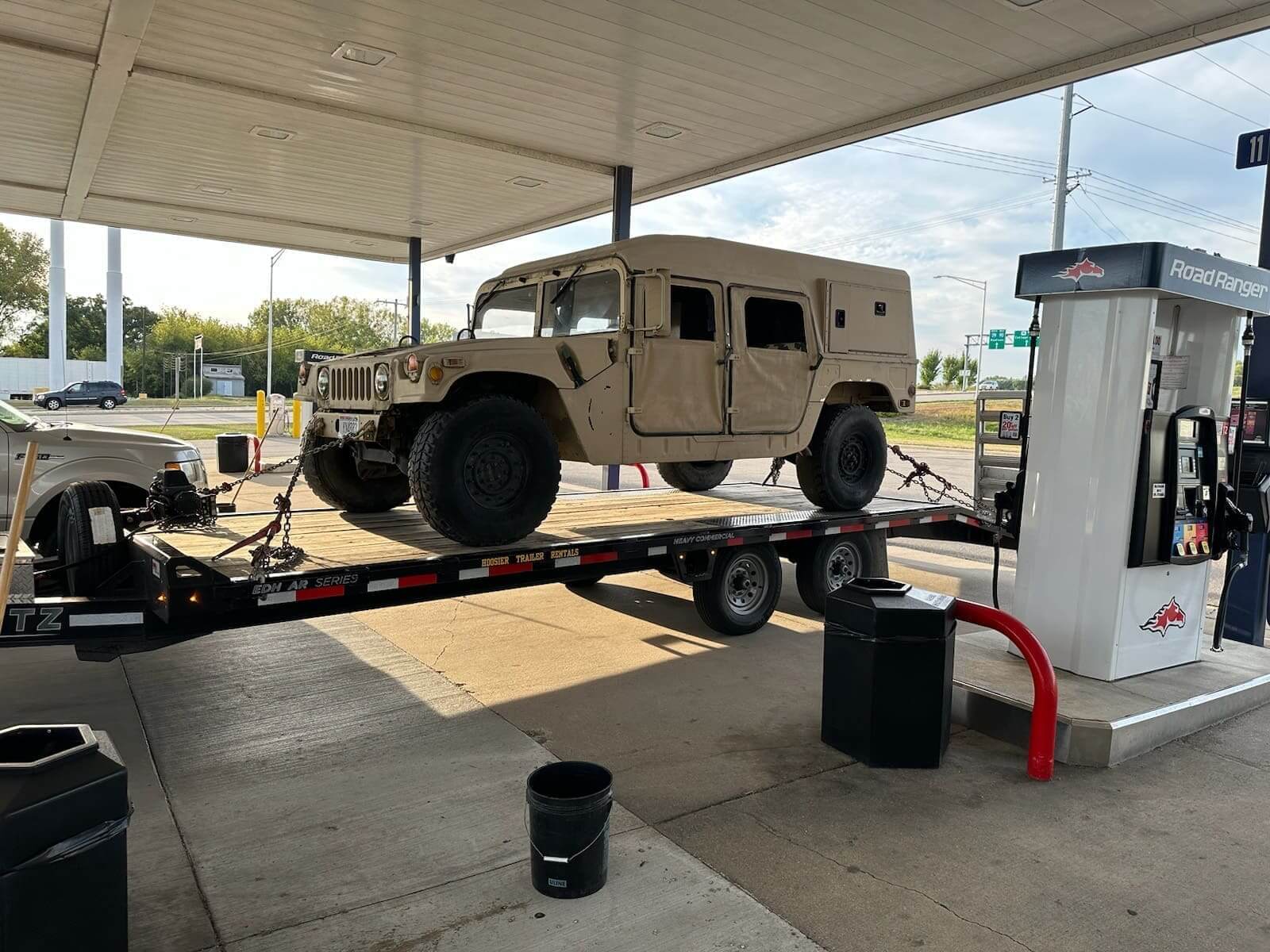 A truck is being loaded onto the trailer.