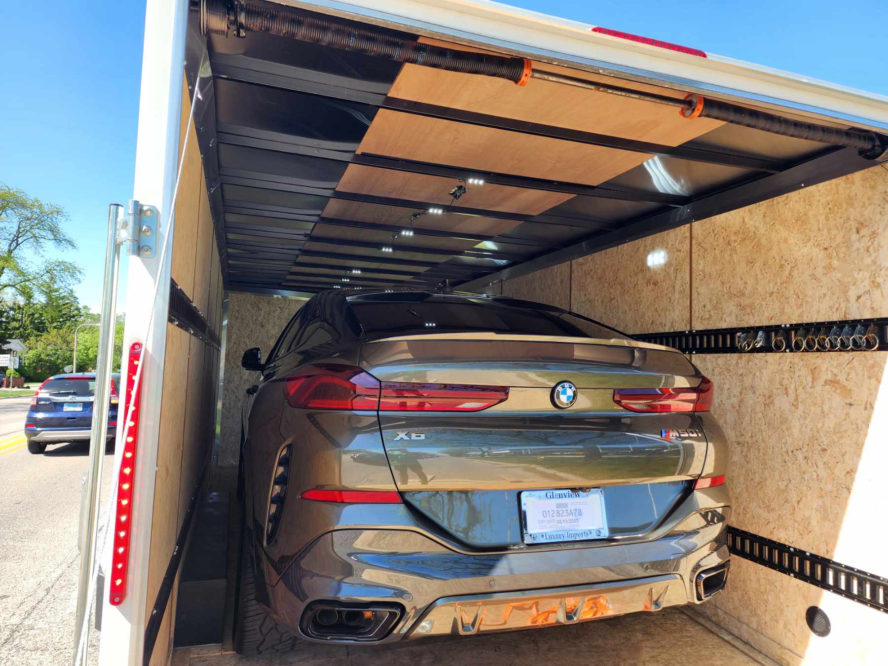 1000006319 A car is being loaded onto the back of a truck.