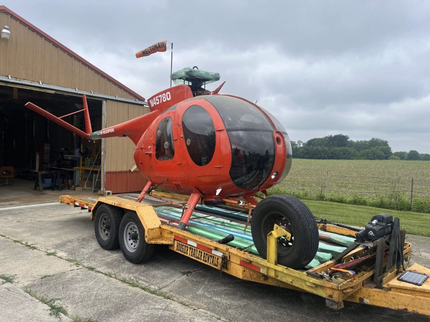 A helicopter is being transported on a trailer.